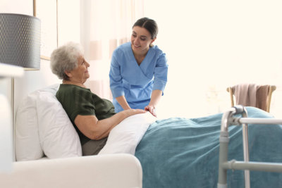 Care worker with elderly women in geriatric hospice