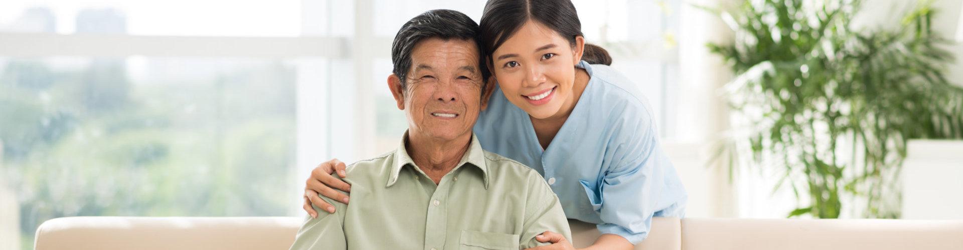 an elderly man and a caregiver woman