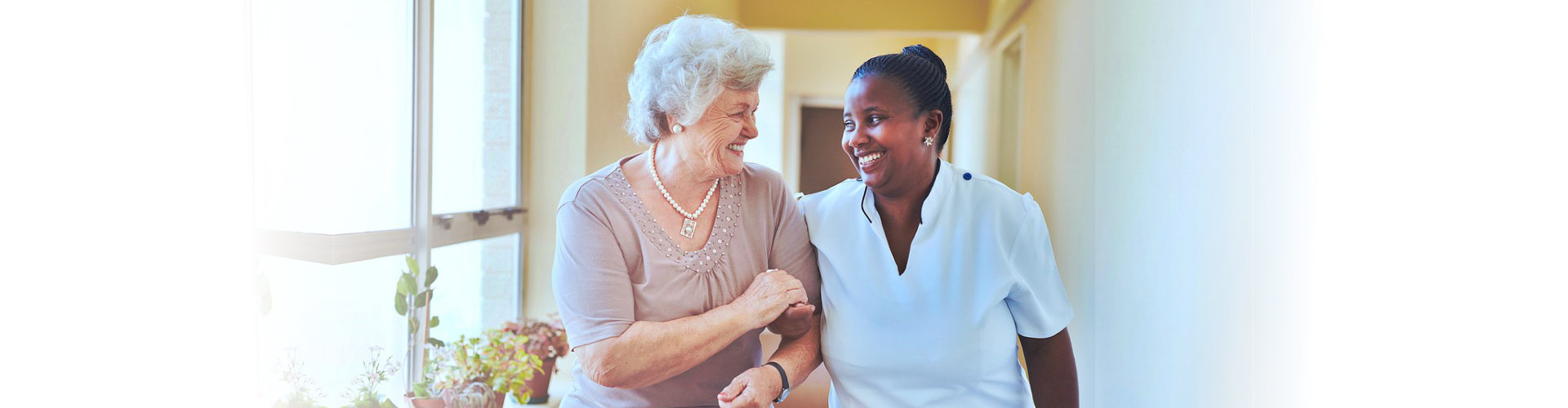 senior woman and caregiver looking at each other